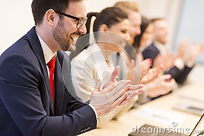 Group of business people clapping their hands at the meeting Stock Photo
