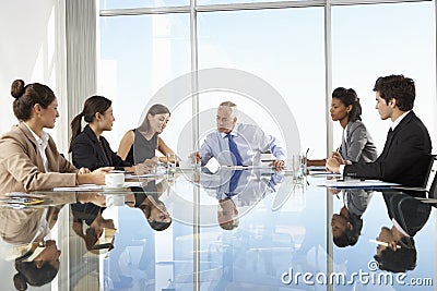 Group Of Business People Having Board Meeting Around Glass Table Stock Photo