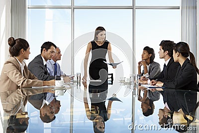 Group Of Business People Having Board Meeting Around Glass Table Stock Photo