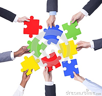 Group of Business People Holding Jigsaw Stock Photo