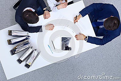 Group of business people and lawyer discussing contract papers sitting at the table, view from above. Businessman is Stock Photo