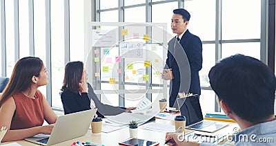 Group of business people meeting in conference room. Asian businessman speech, present teamwork partnership. Happy business people Stock Photo