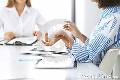 Group of business people at meeting in office, close-up. Team of two women discussing deal. Negotiation concept Stock Photo