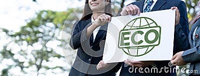 Group of business people stand united, holding eco-friendly idea. Gyre Stock Photo