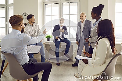 Group of business people talking on a meeting at the working place in office. Stock Photo