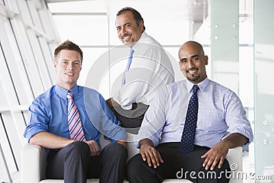 Group of businessmen sitting in lobby Stock Photo