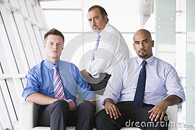 Group of businessmen sitting in lobby Stock Photo