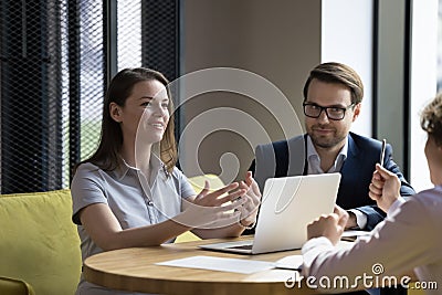 Group of businesspeople gathered in office take part in briefing Stock Photo
