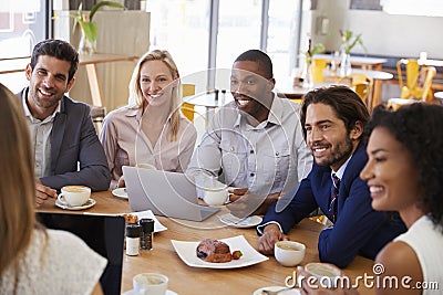 Group Of Businesspeople Having Meeting In Coffee Shop Stock Photo