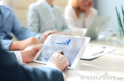 Group of businesspeople looking at graphs Stock Photo