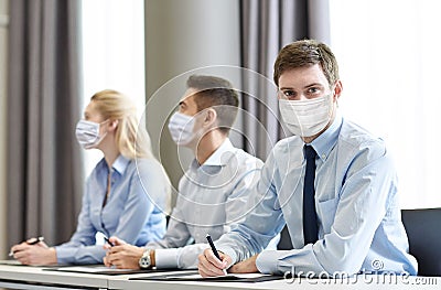 Group of businesspeople in masks meeting at office Stock Photo