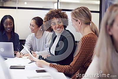 Group Of Businesswomen Collaborating In Creative Meeting Around Table In Modern Office Stock Photo