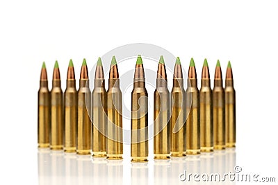 A group of 5.56 calibar, green tip bullets ordered into the lines on white background Stock Photo