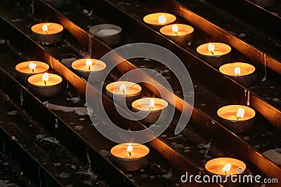 Group Of Candles In Church. Candles Light Flame Stock Photo