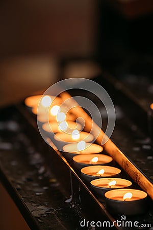 Group Of Candles In Church. Candles Light Flame Stock Photo