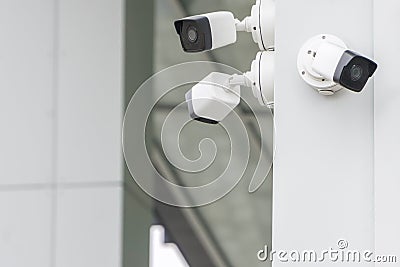 Group of CCTV security cameras outside on modern building wall in city Stock Photo