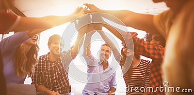 Cheerful business people giving high five while sitting creative office Stock Photo