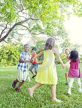 Group of Cheerful Children Playing in the Park Stock Photo