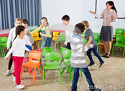 School kids playing active games with teacher Stock Photo