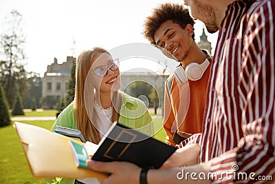 Group of cheerful students sharing good news discussing exam results Stock Photo