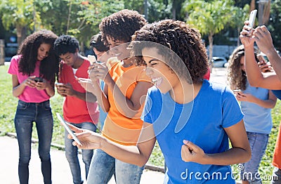 Group of cheering people using 4g with phone Stock Photo