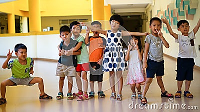Qingyuan, China - June 23, 2016: 8 Asian kids at the kindergarten having fun and playing with each other Editorial Stock Photo