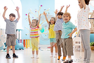 Group of children doing kids gymnastics in kindergarten Stock Photo