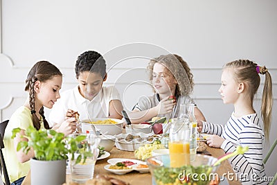 Group of children eating healthy dinner Stock Photo