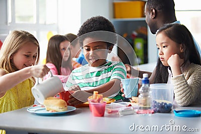 Group Of Children Eating Lunch In School Cafeteria Stock Photo