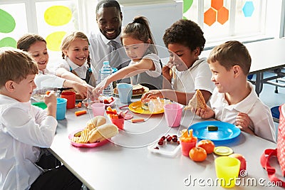 Group Of Children Eating Lunch In School Cafeteria Stock Photo