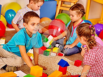 Group children game blocks on floor . Stock Photo