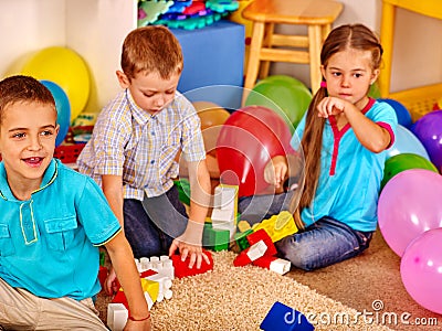 Group children game blocks on floor . Stock Photo