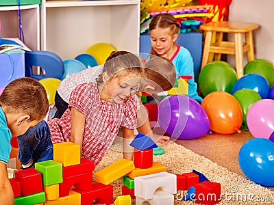 Group children game blocks on floor . Stock Photo