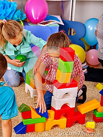 Group children game blocks on floor . Stock Photo