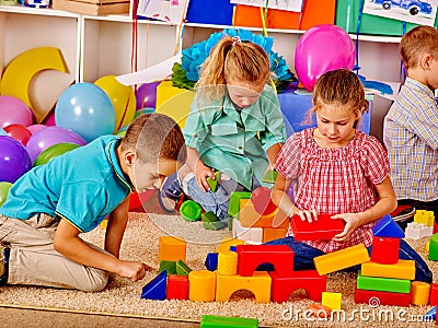 Group children game blocks on floor . Stock Photo