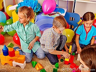 Group children game blocks on rug . Stock Photo