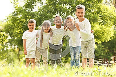 Group of children huddling in park Stock Photo