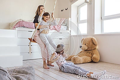 Kids paljamas party in white bedroom interior Stock Photo