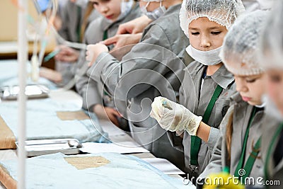 A group children medical training. A group of children are studying surgery. Teaching medicine. Young doctors at a seminar in a Editorial Stock Photo