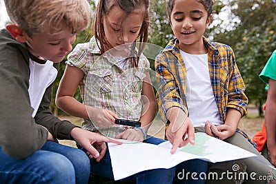 Group Of Children On Outdoor Activity Camping Trip Looking At Map Together Stock Photo