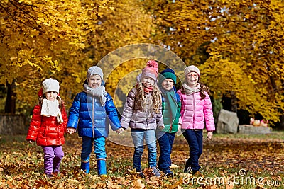 A group of children play in the park yellow autumn. Little boys Stock Photo