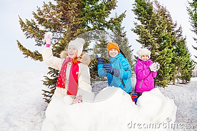 Group of children play snowballs game in forest Stock Photo