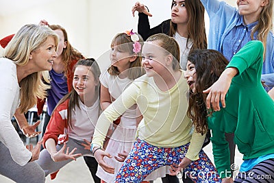 Group Of Children With Teacher Enjoying Drama Class Together Stock Photo