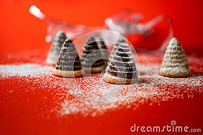Group of christmas beehive cake on snowy red background with blurred silver ribbon Stock Photo