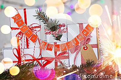 Group Christmas white gift boxes with red ribbons and garland Merry Christmas. Stock Photo