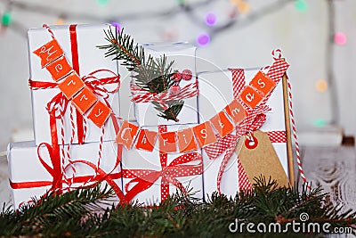 Group Christmas white gift boxes with red ribbons and garland Merry Christmas. Stock Photo
