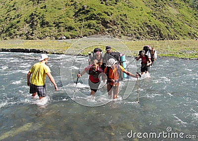 Group of climbers crossing river Editorial Stock Photo