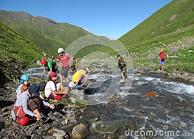 Group of climbers crossing river Editorial Stock Photo