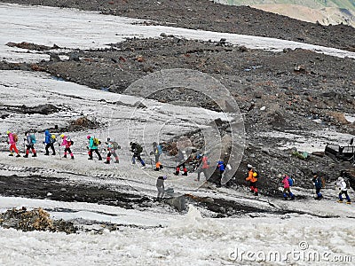 Group of climbers with trekking poles climbs Mount Elbrus Stock Photo