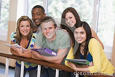 Group of college students leaning on banister Stock Photo